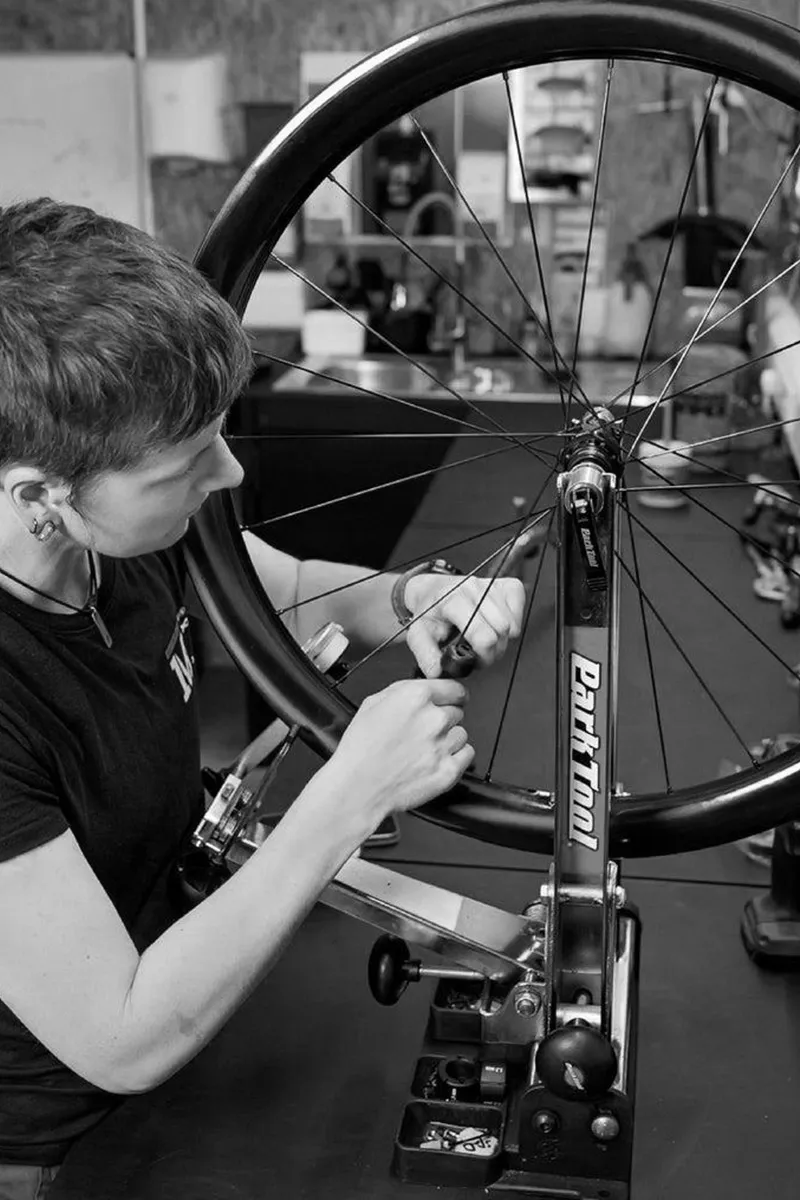 mechanic truing a wheel